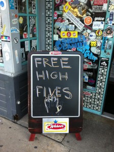 Sandwich board out front of Wahoo's Fish Tacos says "Free High Fives"